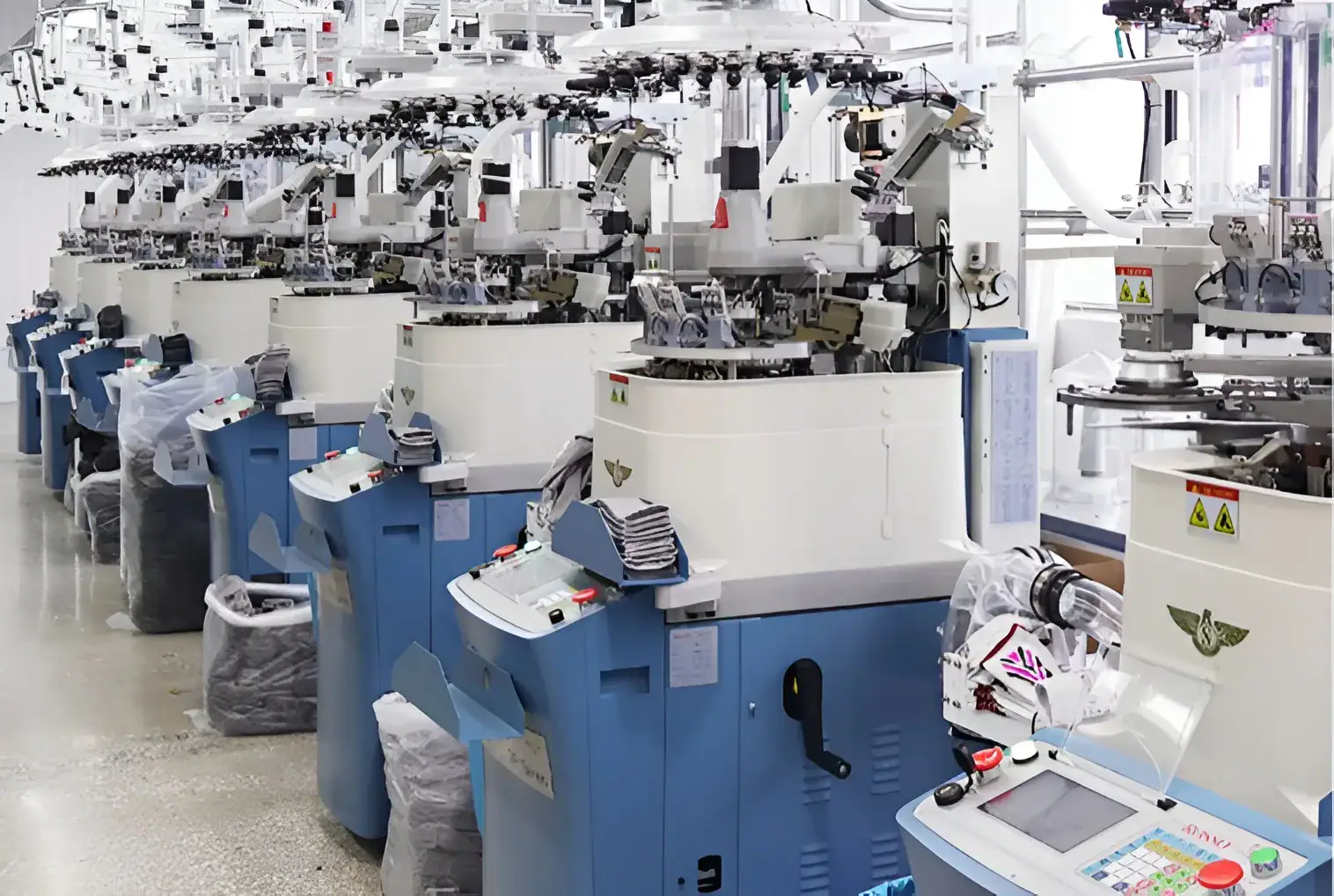 Automated sock knitting machines in a textile factory setting.